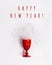 Red festive wine glass from which snow scattered, creative concept of winter holidays, Christmas party. Colored