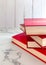 Red fiction,novels are stacked on marble floors, white wood wall backgrounds