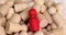 Red figurine of human in crowd of people