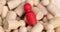 Red figurine of person in crowd of people lies in pile