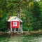 Red Finnish Wooden Bath Sauna Log Cabin On Island In Summer