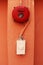 Red fire alarm on orange wall