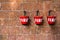 Red fire bin contain sand on brick wall background