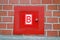 Red fire box for hydrant, red brick wall, modern security,