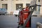 Red fire extinguishers in a stand in a petrol pump station with Arabic writing