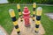 Red fire hydrant surrounded by yellow-black pillars against a green lawn. Prevention system.