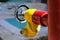 Red fire hydrant with yellow connectors. Fire hydrant or fire pump, represents the point of connection, through which firefighters