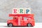 Red fire truck hold block in word ERP Abbreviation of Enterprise Resource Planning on wood background