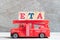 Red fire truck hold block in word ETA abbreviation of estimated time of arrival on wood background