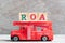 Red fire truck hold block in word ROA Abbbreviation of Return on assets on wood background