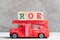 Red fire truck hold block in word ROE Abbreviation of Return on equity on wood background