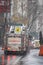 Red fire truck portrait cruising through wet snow storm city streets