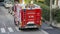 Red fire truck in the streets of the city to provide first aid in case of emergency. Tank lorry. Street of Italy