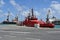 Red fireboat designed for firefighting and fire extinguishing of vessels and port infrastructure is moored in passenger terminal.