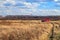 Red firetruck car rides through the autumn field with yello