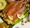 red fish, avocado, nuts dinner natural selection on white wooden background, healthy food