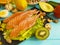 Red fish, avocado, organic nuts on a blue wooden background, healthy food fresh