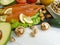 Red fish, avocado, tomato lemon nuts dinner natural selection on white wooden background, healthy food