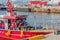 Red fishing boat docking at seaport