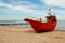 Red fishing boat on the seashore