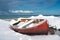Red fishing boats covered with snow