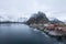 Red fishing house village among the snow with mountain view in Lofoten island Hamnoy Norway