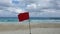 Red flag Alert, warning dangerous to swimming in sea. Red flag flying on beach with sound of winds and sea waves.