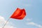 Red flag on the beach. Warning about the dangers