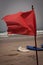 Red flag flap on the beach