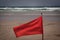 Red flag flap on the beach