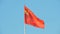 The red flag with the hammer and sickle of the Union of Soviet Socialist Republics USSR is flying in the wind