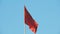 The red flag with the hammer and sickle of the Union of Soviet Socialist Republics USSR is flying in the wind
