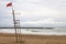 A red flag in a lifeguard tower warn swimmers of danger of bathing in the beach