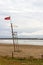 A red flag in a lifeguard tower warn swimmers of danger of bathing in the beach