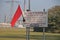 Red flag on schooting area with warnings for danger. This shooting area for skeet shooting on the maasvlakte harbor in Rotterdam.