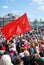 Red flag waves above people\'s heads.