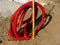 Red flexible PVC hose coiled up with communication cable inside