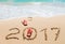 Red flip flops and digits 2017 on the beach