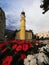 Red flower bouquet view of yellow Heiliger Antonius church chapel in Lienz East Tyrol Austria alps Europe