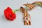 Red flower tied with Saint George ribbon and order of Great Patriotic war