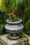 red flowers in old shabby silver vase