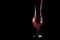 Red fluid puring in to the wine glass