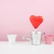 The red foiled chocolate heart stick with small watering can