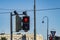 Red forbidding traffic light prohibit for pedestrians to cross the street. Two red little men hugging