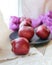 Red fresh apples on a plate, bright cloth on a wooden table, healthy food concept