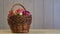 Red fresh apples in a wooden basket on a background of boards with copy space