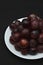 Red fresh grapes. Grapes on a plate. Large grapes