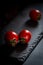 Red fresh healthy tomatoes isolated on a black surface