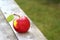 Red, fresh and organic apple on old table