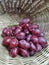 Red Fresh Ripen sweet organic grapes in bamboo basket